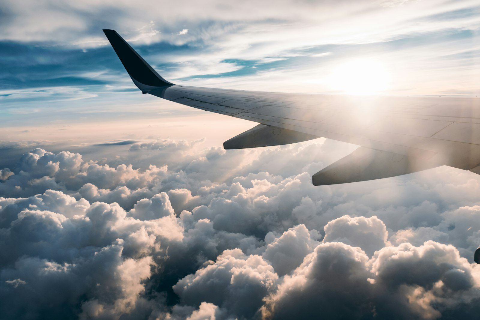 Aircraft wing above clouds