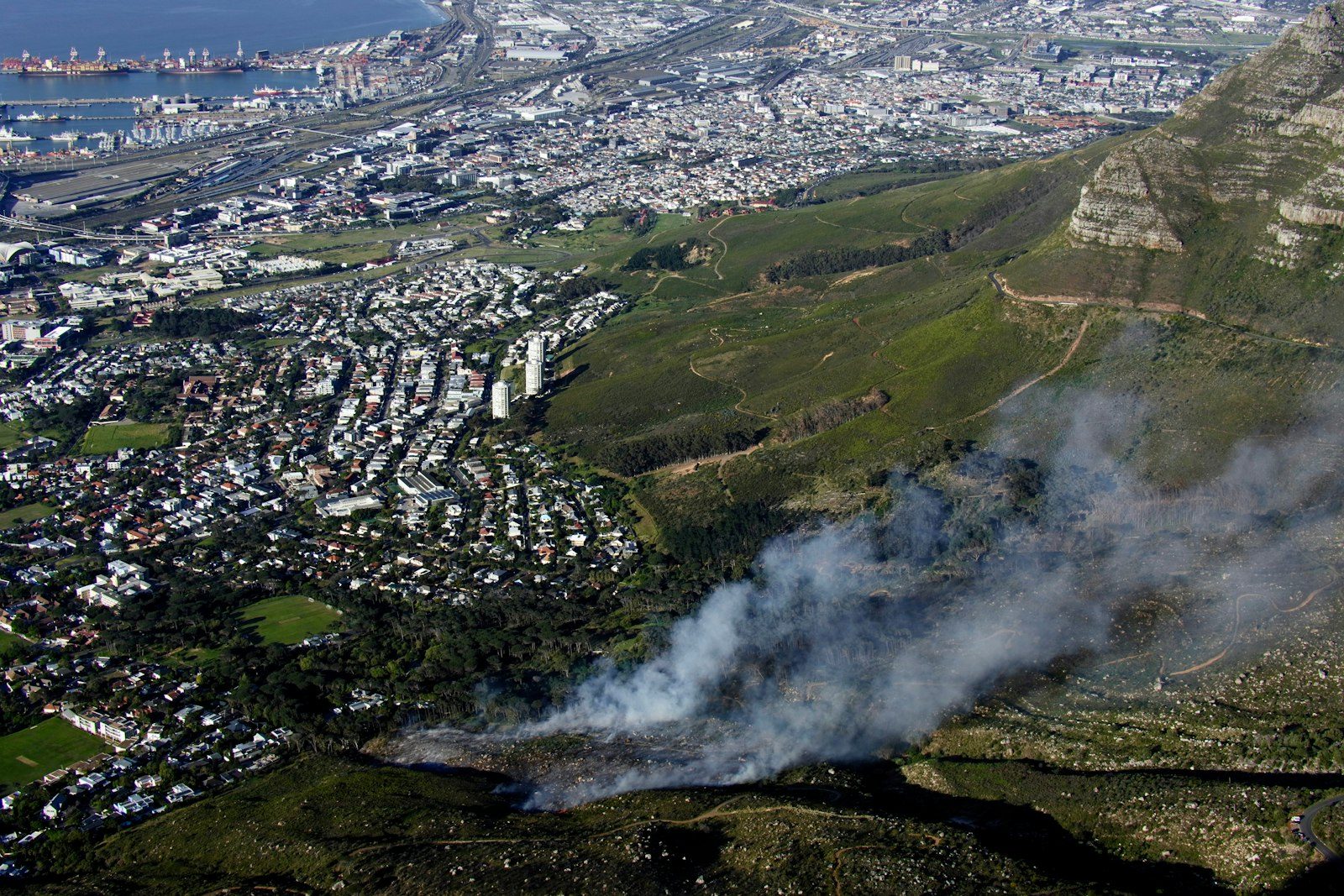 Aerial view of wildfire smoke near a city